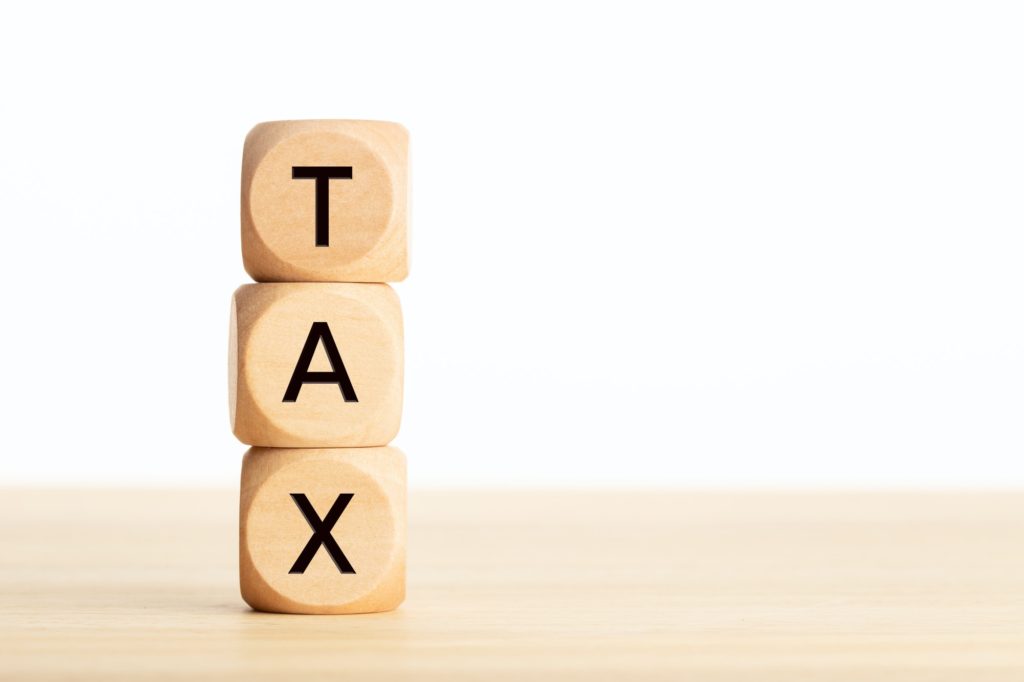 Tax word in wooden blocks on table